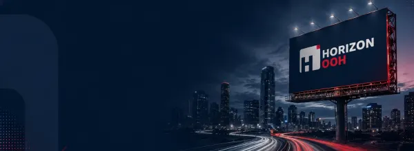 Illuminated HORIZON OOH billboard overlooking a city highway at dusk